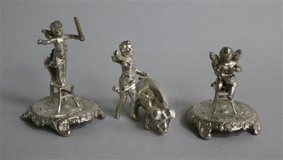 Three late 109th/early 20th century continental silver miniature cherub groups, two with chairs and one with a pig.